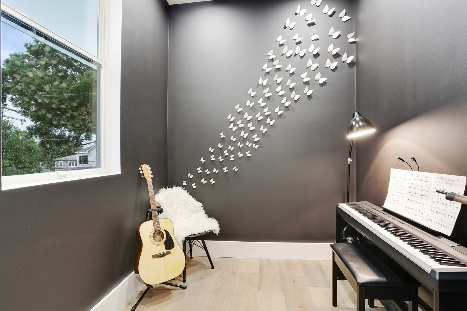Music room with custom butterfly 3D art in Elmeer House luxury new construction home designed and built by DMG Design+Build