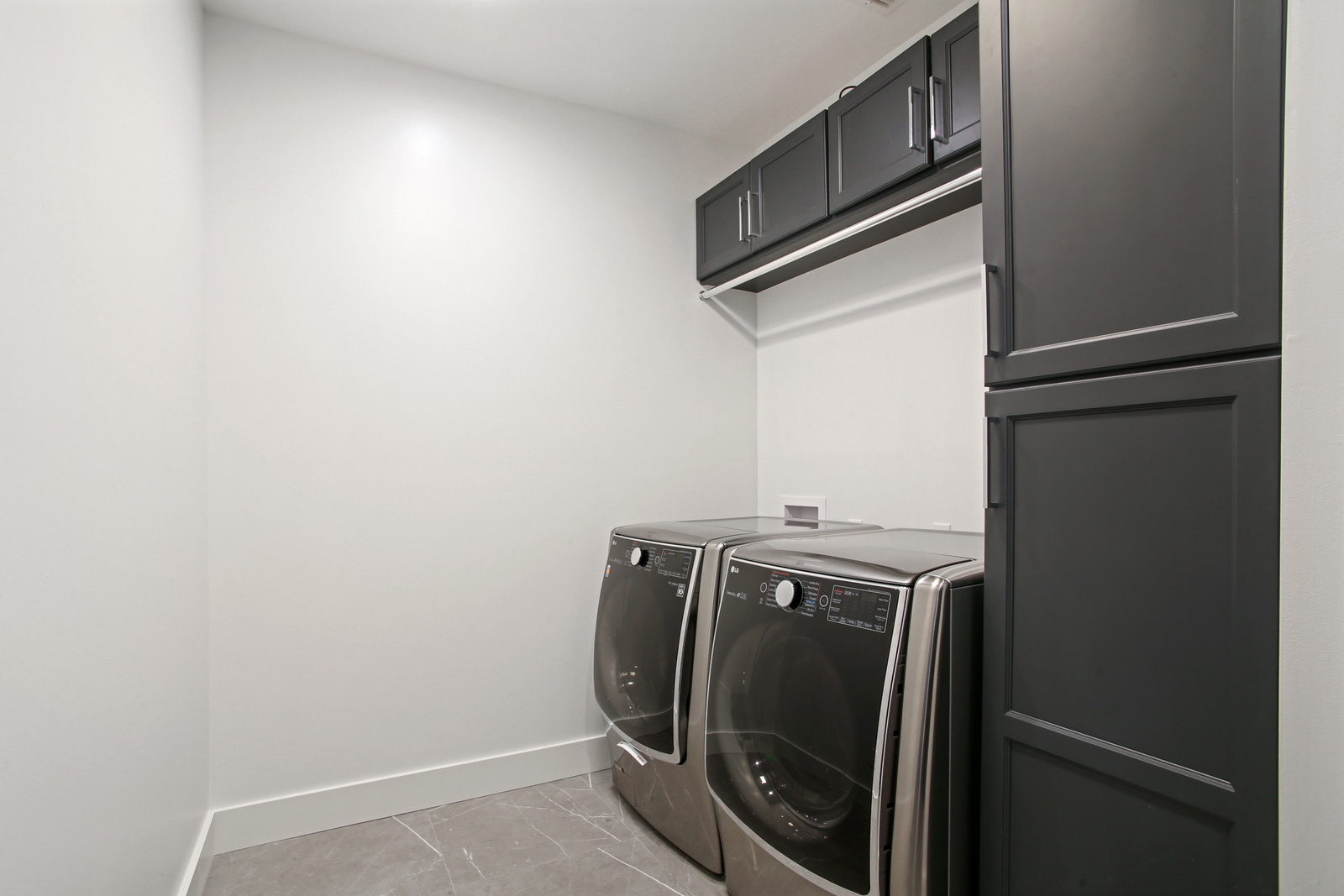 Laundry room in Pratt House new construction custom home designed and built by DMG Design+Build